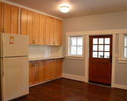 Kitchen Includes Refrigerator and Back Door Opens to Deck