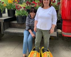 two ladies posing with wooden shoes