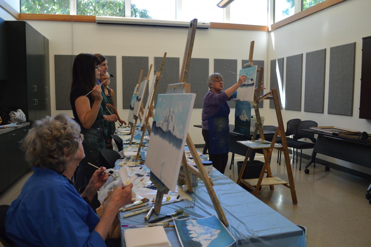 Judy Stubb teaches a Bob Ross style oil painting class